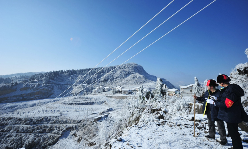 2018年1月9日，務(wù)川供電局豐樂供電所工作人員在貴州務(wù)川仡佬族苗族自治縣石朝鄉(xiāng)巡線。（新華社記者 陶亮 攝）