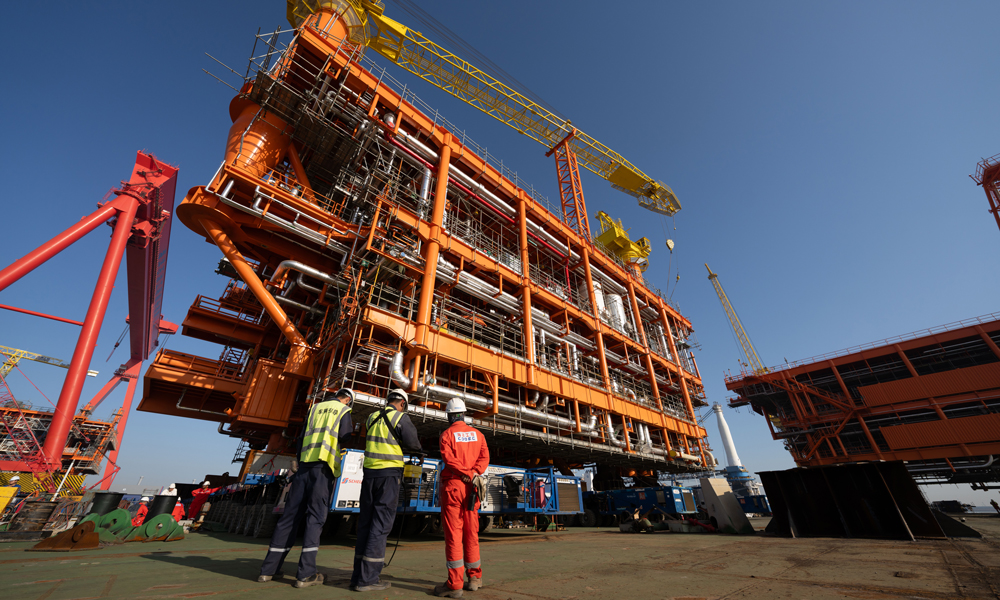 工作人員從駁船回到碼頭，朝車間走去，他們顧不上休息，不久后，正在岸邊加緊建造的生活樓也要從他們手中送到海上去，送到油氣生產平臺上，為國內油氣增儲上產注入澎湃動能。