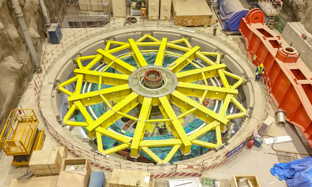 華能硬梁包水電站總裝機(jī)容量111.6萬(wàn)千瓦，總投資126.92億元。2019年10月電站主體工程開(kāi)工建設(shè)，2021年11月實(shí)現(xiàn)大江截流，2023年10月關(guān)鍵線路2號(hào)引水隧洞實(shí)現(xiàn)全線貫通，計(jì)劃2024年10月首臺(tái)機(jī)組發(fā)電，2025年4月全部機(jī)組投產(chǎn)發(fā)電。電站建成投產(chǎn)后，平均年發(fā)電量超50億千瓦時(shí)，每年可節(jié)約原煤消耗223萬(wàn)噸，減少二氧化碳排放357萬(wàn)噸。圖為華能硬梁包水電站廠房樞紐建設(shè)現(xiàn)場(chǎng)。