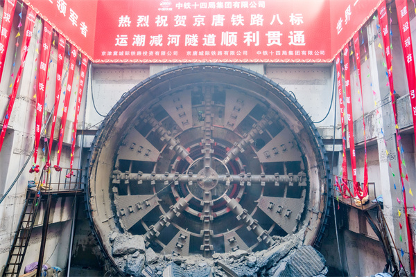 6月25日，由中國鐵建所屬中鐵十四局承建的京唐城際鐵路運(yùn)潮減河隧道順利貫通，標(biāo)志著京唐城際鐵路所有隧道均已貫通，為全線開通運(yùn)營奠定了堅實(shí)基礎(chǔ)。圖為“京通號”盾構(gòu)機(jī)順利抵達(dá)接收井現(xiàn)場。