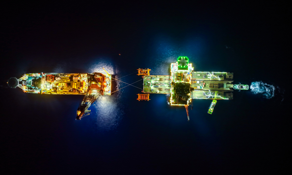 由于平臺上部組塊重量超過全球海上浮吊的能力極限，項目團隊投入亞洲最大海洋工程駁船“海洋石油229”，采用浮托技術進行海上安裝。浮托安裝具有可安裝重量大、施工周期短、技術風險低等顯著優勢。該技術核心是借助潮汐的自然力量和船舶調載等施工技術，通過類似舉重運動員“挺舉”的方式，漲潮時駁船托運組塊駛入導管架槽口，落潮時組塊順勢從高位精準落到導管架預定位置上，載荷全部轉移后退出船舶，完成安裝作業。圖為西江30-2B平臺安裝現場。