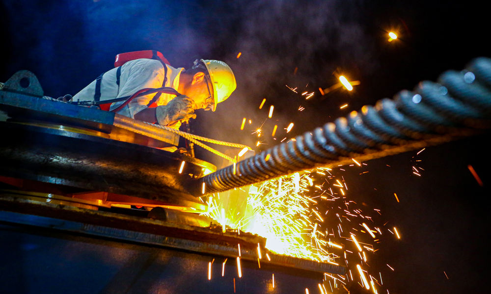 據海油工程西江30-2項目經理介紹，項目組應用數字化工具進行三維建模和計算分析，精心設計浮托技術方案，自主開發多浮筒懸鏈線計算軟件，對系泊布置進行反復優化，浮托作業過程中，通過多拖輪聯動控船，實現了一次精準就位。圖為作業人員在西江30-2B平臺安裝現場進行焊接作業。