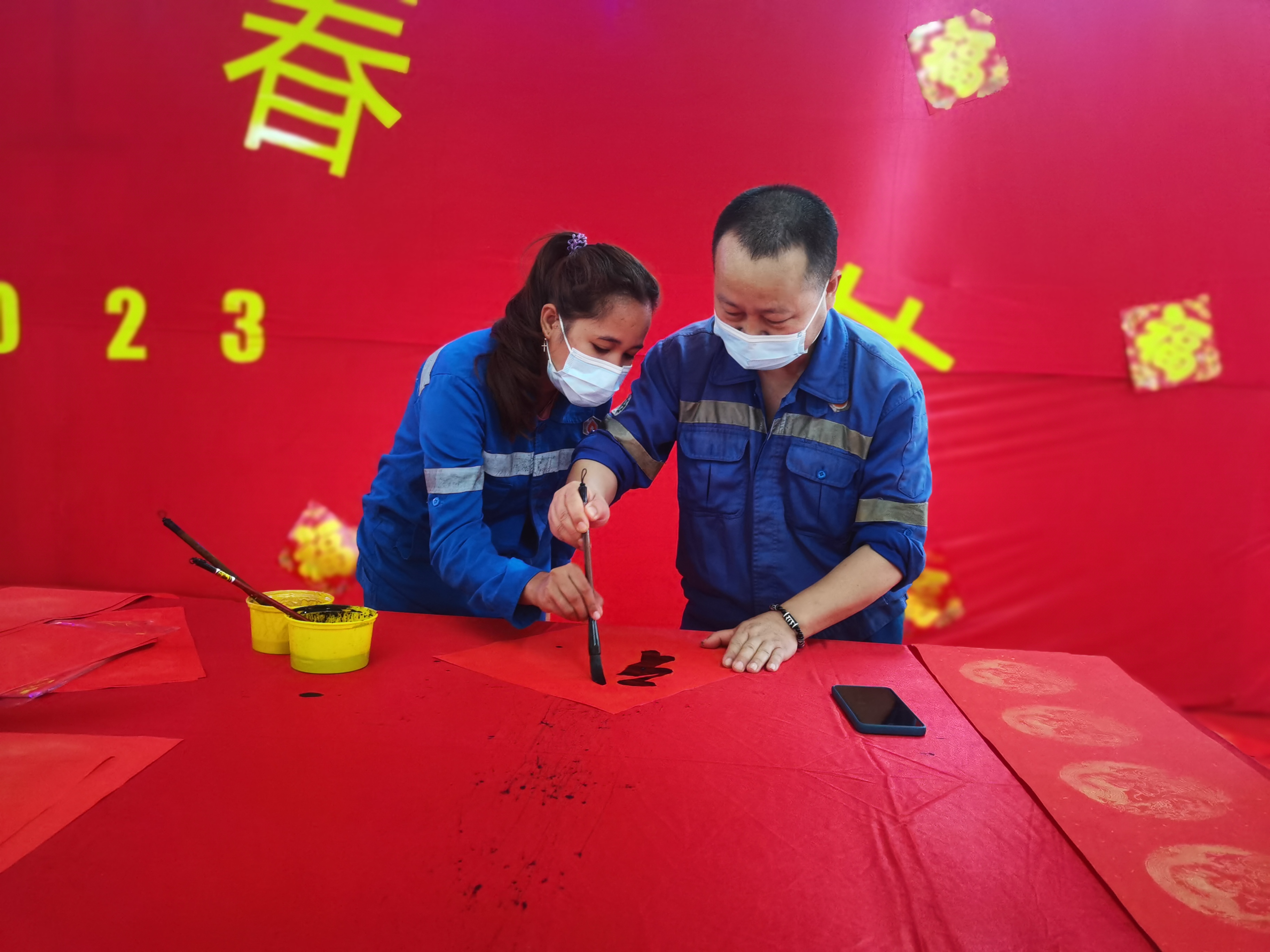 春節(jié)期間中國職工教印尼籍職工寫春聯(lián).jpg 春節(jié)期間中國職工教印尼籍職工寫春聯(lián).jpg